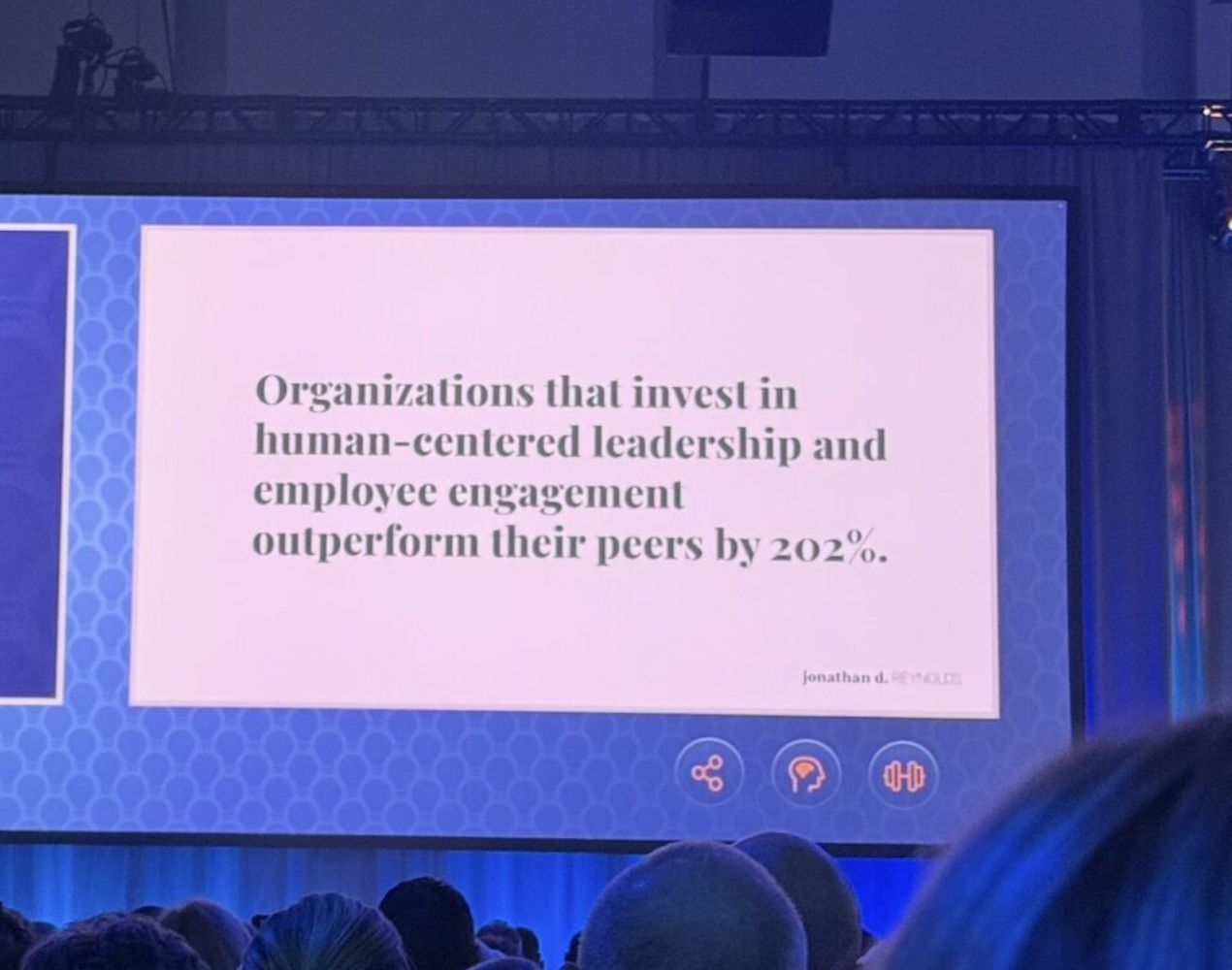 Keynote slide at the EOS® Conference reading: Organizations that invest in human-centered leadership and employee engagement outperform their peers by 202%.